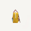 Side view of the Sticky Lemon Backpack Small from the Envelope Collection in Submarine Yellow, featuring a yellow main compartment, white zipper, red and white striped handles, blue pocket, adjustable straps; shown on white background.