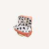 The Sticky Lemon Backpack Large - Envelope - Maple Whirl features pink fabric, yellow handles, a white interior with a black leaf pattern, a yellow circular label inside, and adjustable shoulder straps for comfort.