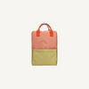 The Sticky Lemon Backpack Large | Color Blocking | Coral Pink + Reed Green features a vibrant color-block design and is crafted from recycled PET bag material.