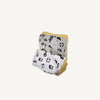 A reed green Sticky Lemon Backpack Large - Envelope, crafted from recycled PET bag material, is open to reveal its white interior lining adorned with black sports-themed illustrations—including soccer balls, jerseys, and athletic figures—set against a plain background.