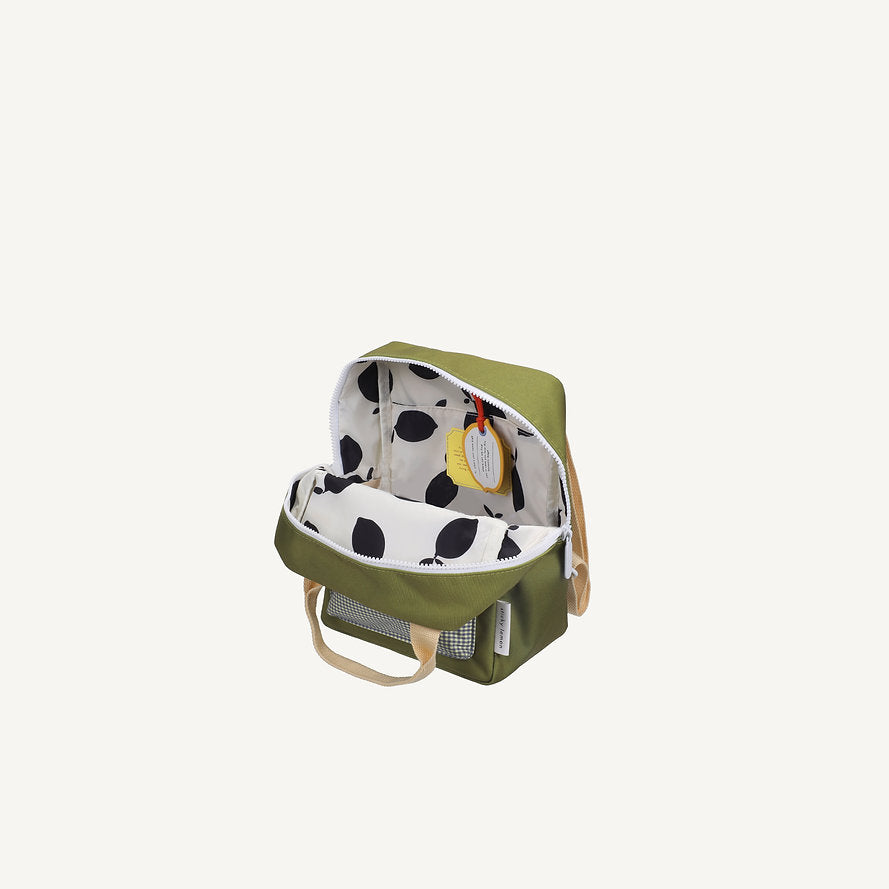 The Sticky Lemon Backpack Small - Envelope - Tickling Grass is a compact olive green waterproof bag with beige handles, a white interior patterned with black leaves, made from recycled PET bottles, and has a yellow tag on the inside zipper.