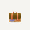 A Sticky Lemon School Bag | Farmhouse | Corduroy Pear Jam with a green textile flap, orange checked straps, and leather accents in tan and purple is displayed against a white background.