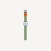 The Sticky Lemon x Mini Kyomo Watch - Apple is a kids' watch with a green patterned strap, two orange bands labeled "ENERGY" and "LEGEND," and a silver rectangular face, shown against a plain white background.