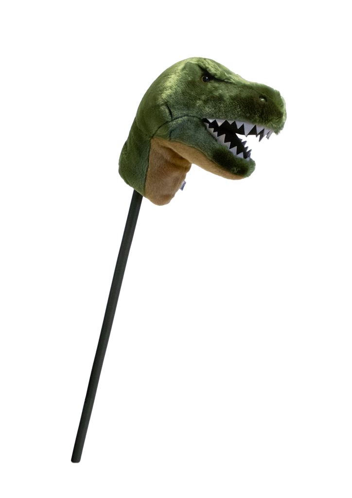 The Hobbyhorse - T-Rex Dino features a plush green dinosaur head with sharp white teeth on a black stick, making it perfect for imaginative play and dinosaur adventures.