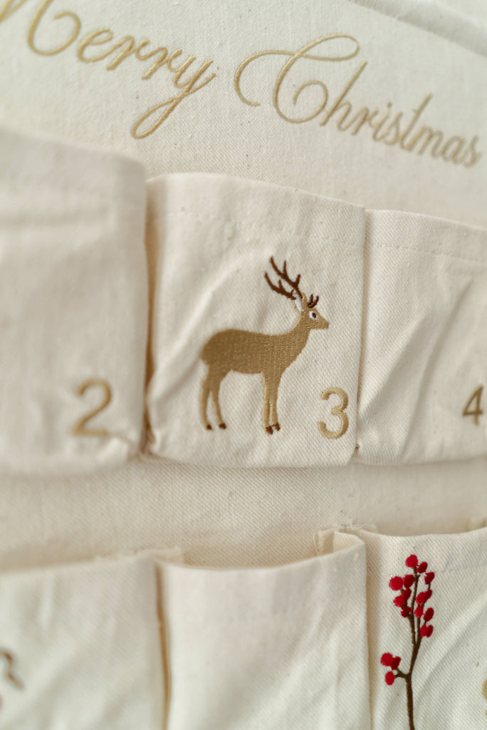 A close-up of the Sabo Concept Christmas Cotton Advent Calendar shows numbered pockets; pocket 3 has a reindeer, and "Merry Christmas" is partially visible at the top.