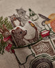 The Coral & Tusk Christmas Tree Car Pocket Pillow features embroidered woodland animals—a 3D bear, rabbit, fox, and cat—riding in a vintage car with a Christmas tree. The bear is three-dimensional and sits in the driver’s seat.