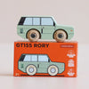 A mint green wooden 4x4 toy car, No. 28 GT155 Rory | Made in England, sits atop an orange box featuring classic British design and icons for sustainable wood, child-safe paints, and UK manufacturing. Suitable for ages 2 and up, this adventure toy is both stylish and safe.