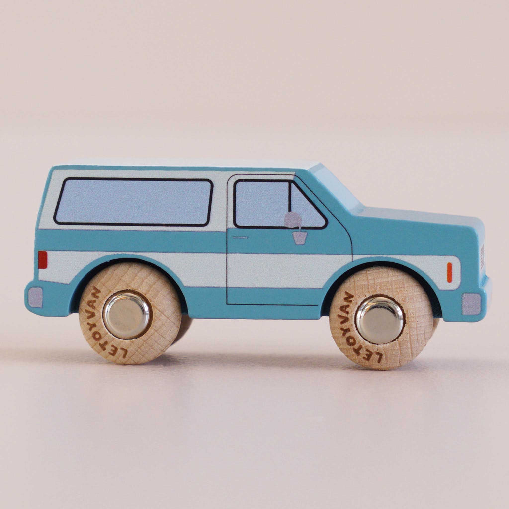 The No. 31 GT170 Chuck, made in England, is a blue and white wooden SUV toy with round wooden wheels, set on a light surface against a light background—perfect for inspiring off-road journeys and imaginative adventure toy play.
