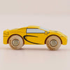 The No. 19 GT105 Louis, a yellow wooden toy car with black detailing and round wooden wheels styled as a classic toy car, is shown in side view on a light background. Made in England.