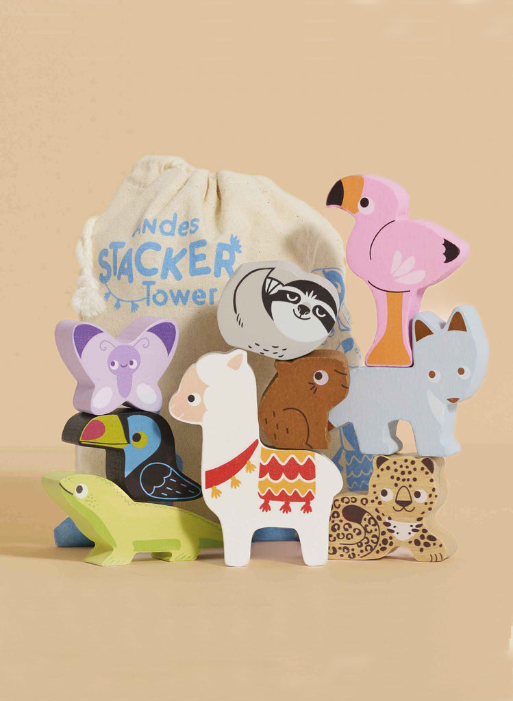 A set of colorful wooden animal blocks—including a flamingo, sloth, butterfly, bear, llama, dog, lizard, and cheetah—is stacked in front of a cloth bag labeled "Andes Stacking Animals & Bag" on a beige background. Perfect for sensory play.