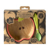 The Pepa the Apple Bowl & Spoon Set is a non-toxic, apple-shaped bamboo baby dinnerware set with a red rim, green leaf detail, and green spoon. Packaged in an "Oli&Carol Dinnerware" box for ages 6 months and up.