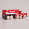 Introducing the No. 33 GT180 Toby | Made in England: A red wooden truck with six wheels, white detailing, and “Bubbles of Joy!” on its side, displayed on a light background. This vintage-inspired design sparks imaginative storytelling and playtime adventures.