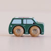 The No. 7 GT45 Molly, made in England, is a small green wooden car inspired by classic British toys, featuring black windows and wheels crafted from both wood and metal, presented against a light background.