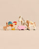 A set of Holztiger Handmade Wooden Farm Animals including a rabbit, a rooster, a pig, a horse, and a goat.