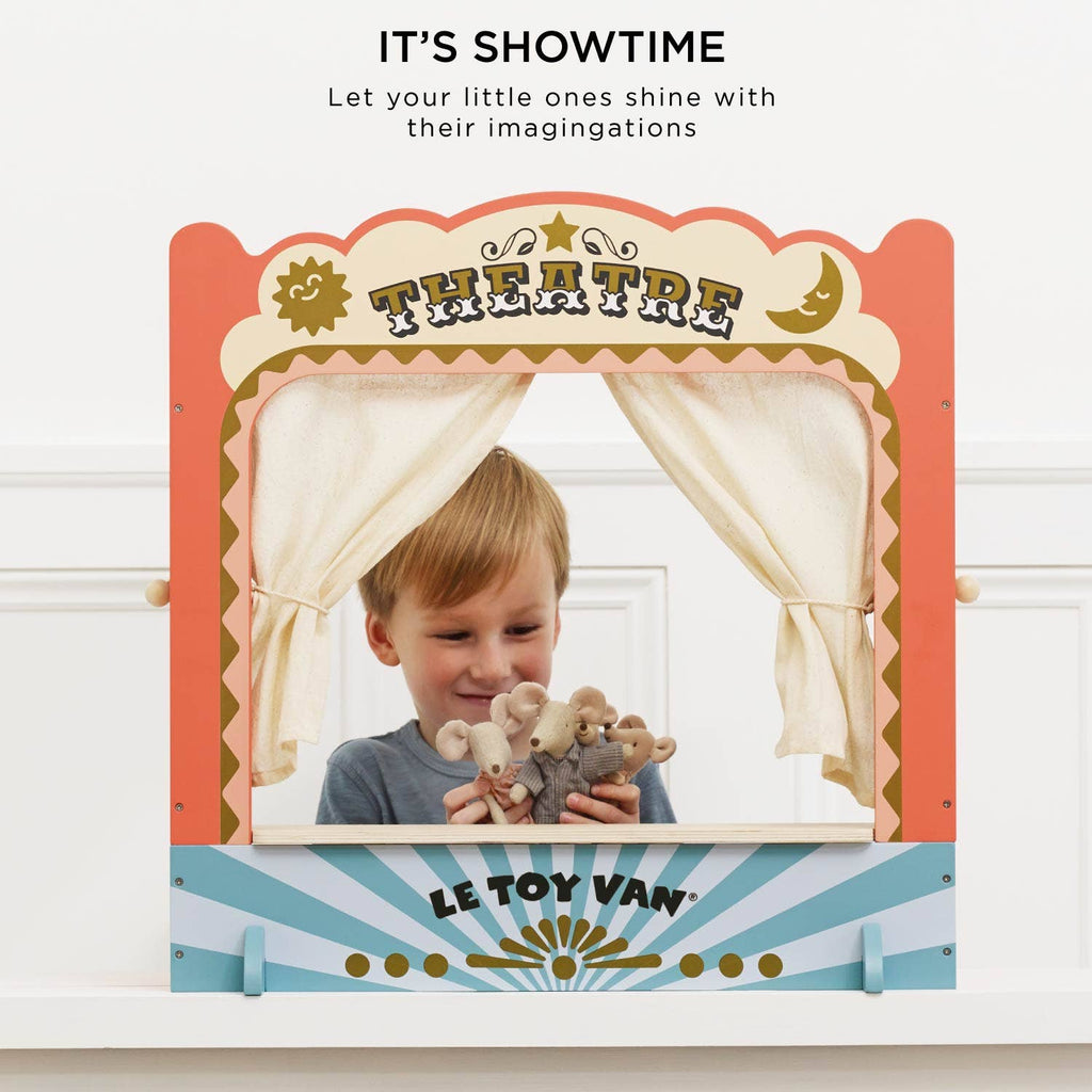 A young child smiles while playing with mouse puppets behind the Tabletop Puppet Wooden Theater, featuring colorful curtains. The text above says, "IT'S SHOWTIME. Let your little ones shine with their imagination.