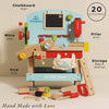 The Wooden Tool Bench features labeled parts: chalkboard sign, mitre saw, vice grip, pillar drill, storage bag & shelves. Ideal for pretend play with 20 accessories and small wooden tools. “Hand Made with Love” is written below.