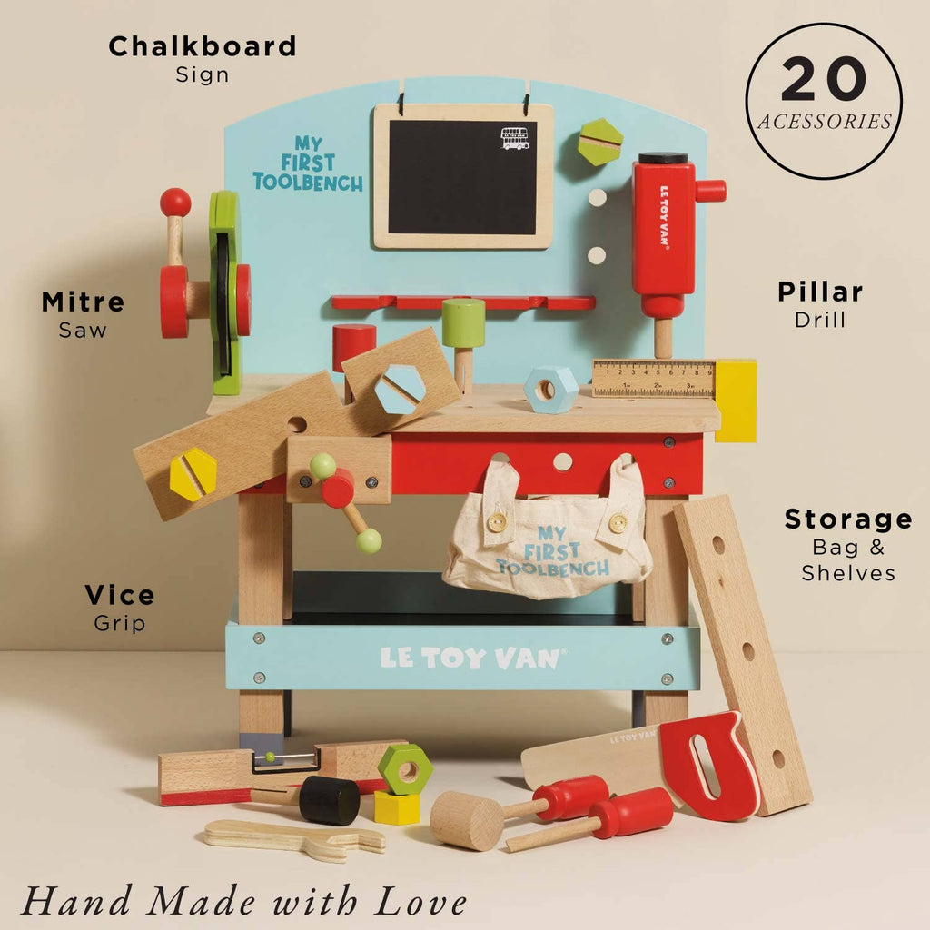 The Wooden Tool Bench features labeled parts: chalkboard sign, mitre saw, vice grip, pillar drill, storage bag & shelves. Ideal for pretend play with 20 accessories and small wooden tools. “Hand Made with Love” is written below.