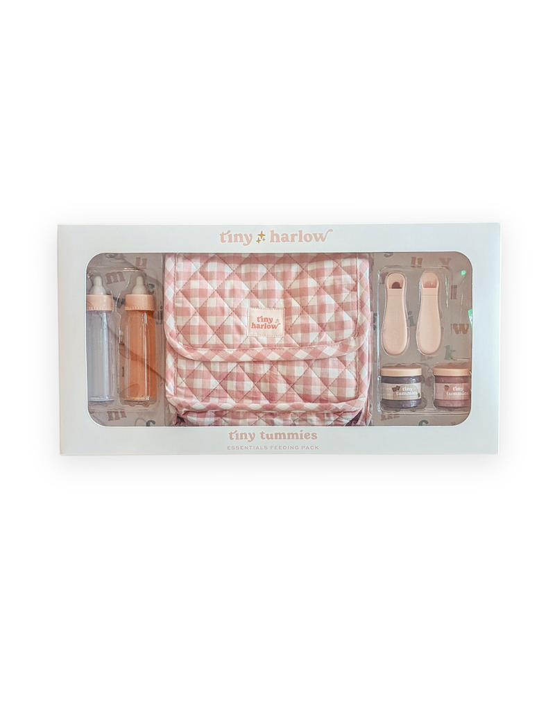 The Tiny Tummies Pink Gift Box by Tiny Harlow is a charming pink and white checkered set teeming with feeding essentials for tiny tummies. This delightful white box contains bottles, utensils, and containers, making it perfect for doll essentials' playtime.