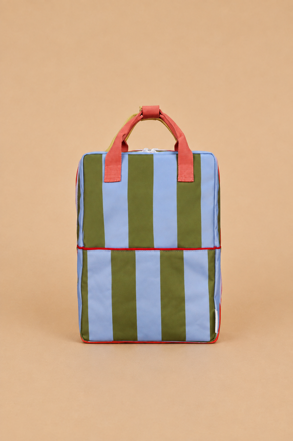 The Sticky Lemon Backpack Large | Stripes | Tickling Grass + Cloud Blue (ships in a week) is a rectangular backpack with vertical olive green and light blue stripes, red handles and trim, made from recycled PET bottles, and featuring adjustable shoulder straps. It is displayed against a plain beige background.