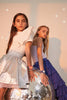 Two girls in stylish outfits lean against a large disco ball, each wearing a Mini Kyomo Watch - Disco. These kids watches add a playful touch as they pose confidently under soft lighting.