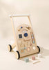 Wooden Activity Walker featuring colorful beads, shape sorters, a spinning mirror, gears, and blocks—designed as an engaging baby walker for interactive play and early sensory development. Neutral background.