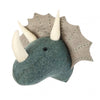 A handcrafted felt triceratops wall decor - mini resembling a triceratops, mainly in a teal color with white horns and a beige frill, displayed against a white background.