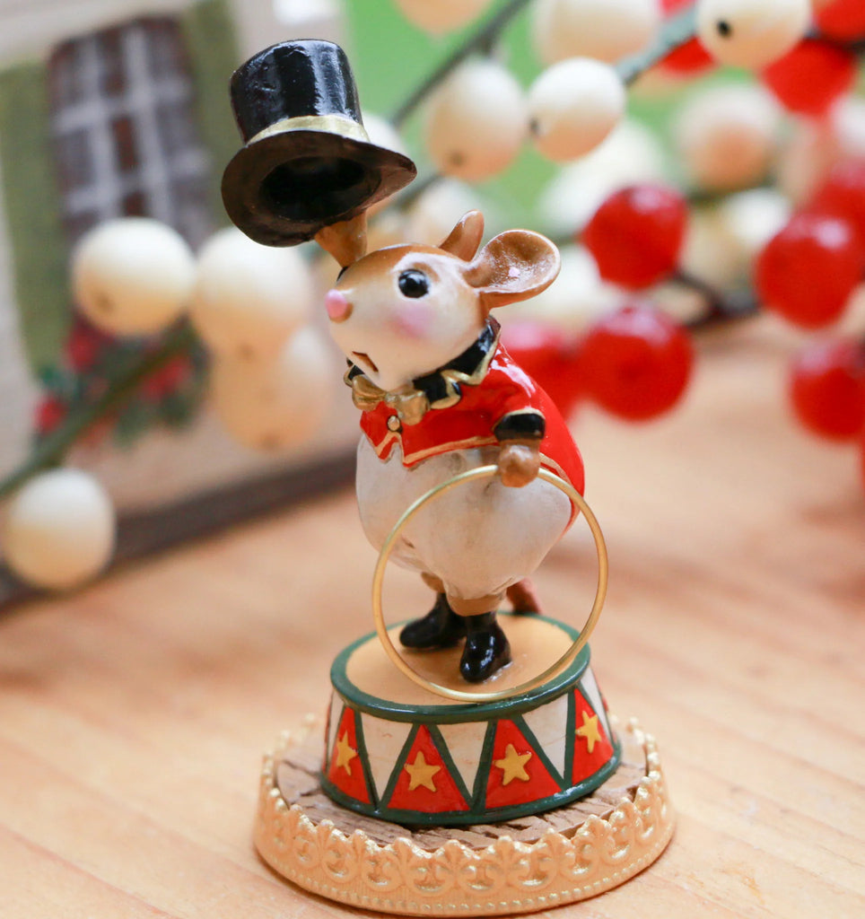 The Wee Forest Folk Tiny Collectible - Gold Rings features a mouse ringmaster on a decorated pedestal with a top hat and ring, holiday berries in the background—a charming collectible figurine.