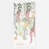 Illustration of a Meri Meri floral paper backdrop with hanging green and pink vines and assorted flowers, made from sustainable FSC paper, against a white background, labeled "Meri Meri Floral Paper Backdrop.