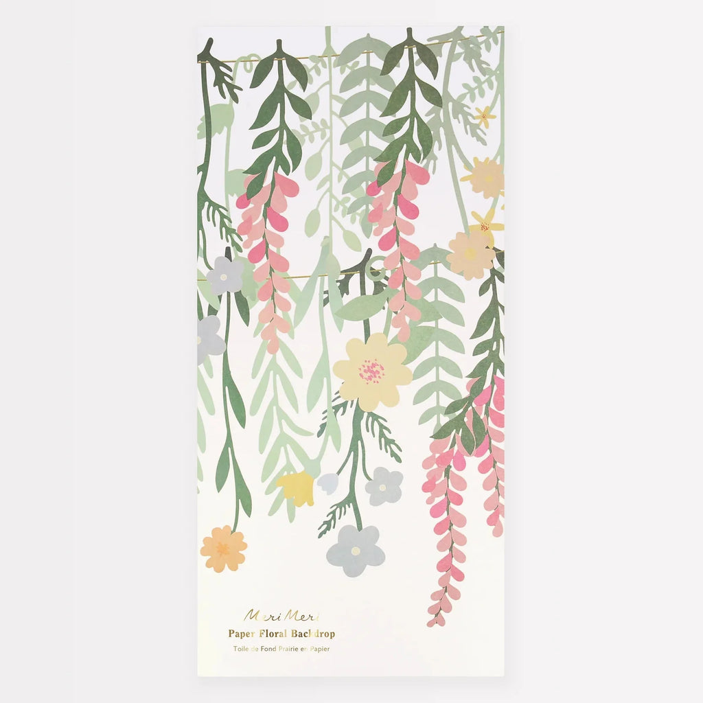 Illustration of a Meri Meri floral paper backdrop with hanging green and pink vines and assorted flowers, made from sustainable FSC paper, against a white background, labeled "Meri Meri Floral Paper Backdrop.