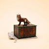A Fox Cake Topper—now a final sale item—stands atop a vintage wooden chest draped with a light tasseled cloth against a beige background, creating an enchanting collectible keepsake perfect for display in any cherished space.