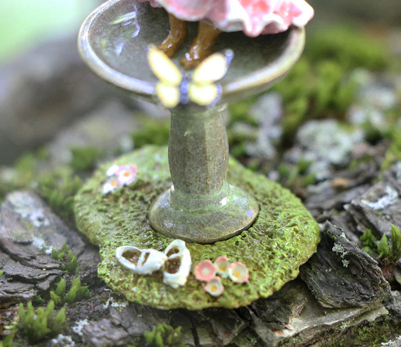 The Wee Forest Folk Tiny Collectible - Garden Spa (Not a Toy) features a hand-sculpted mouse at a birdbath, with a butterfly, tiny white shoes, pink flowers, and mossy bark—perfect for miniature collectors.