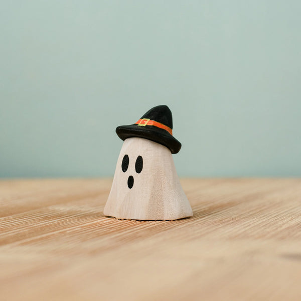 Bumbu Handmade Wooden Ghost Wizard figurine wearing a small black hat with an orange band, perfect as a Waldorf toy.