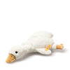 The Steiff Gilda Goose Rattle is a soft, white plush goose toy with a yellow beak and feet, black eye, and yellow tag on one wing. Lying on its side against a plain white background, it makes an adorable gift for newborns.