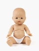 A Minikane Doll with Sleeping Eyes (13") - Lily sits upright in a white diaper with arms slightly out and legs spread against a plain white background. This anatomically correct doll is made in Spain; clothing sold separately.