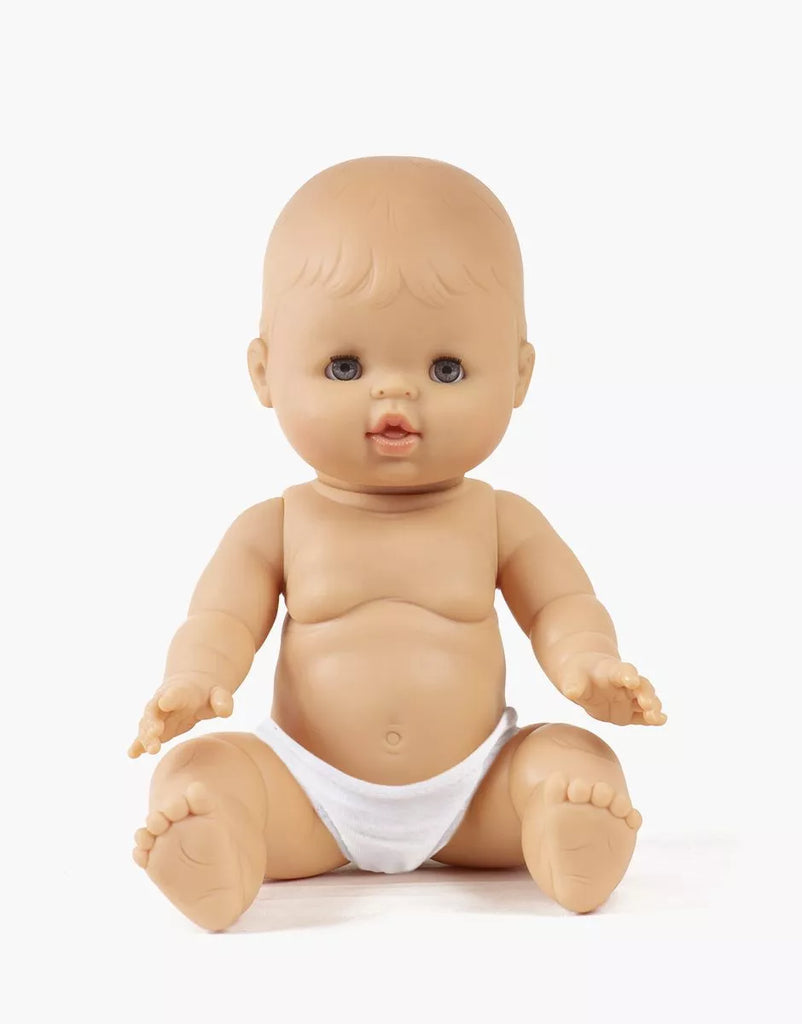 A Minikane Doll with Sleeping Eyes (13") - Lily sits upright in a white diaper with arms slightly out and legs spread against a plain white background. This anatomically correct doll is made in Spain; clothing sold separately.