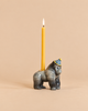 Meet the Gorilla Cake Topper – Final Sale: this whimsical ceramic figurine features a gorilla sporting a striped party hat and carrying a lit yellow candle on its back, set against a neutral beige backdrop. It’s an enchanting collectible keepsake, ideal as a unique birthday gift or playful décor accent.