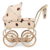 The Konges Sloejd Mini Doll Pram - Strawberry is a beige vintage-style pram with large wheels, a hood, and a bag, featuring red strawberry patterns on quilted fabric.