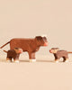 Holztiger Handmade Wooden Highland Cow Family Set featuring a handcrafted wooden Highland cow figure standing with two smaller calves, perfect for open-ended play.