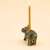 Introducing the Hippo Cake Topper – Final Sale: a whimsical ceramic hippo figurine designed to hold a lit yellow candle on its back. Set against a plain beige backdrop, this eye-catching piece makes for an adorable collectible keepsake—perfect for adding charm and cheer to any celebration or space.