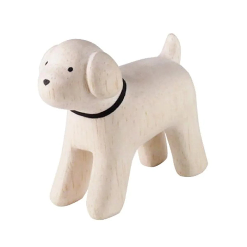 A small, handcrafted Poodle dog figurine with a simple, cartoonish design, featuring visible wood grain, round ears, dot eyes, a nose, and a black collar.