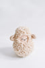 A cute plush Handmade Musical Roly Poly - Lamb toy with curly fleece and closed eyes, set against a plain white background. The lamb features small beige ears, emits musical sounds, and has a serene expression.
