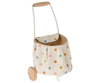 A children's Maileg Mini Bunny & Trolley Set toy shopping trolley on wheels, featuring a polka dot design on a beige background, displayed on a black background.