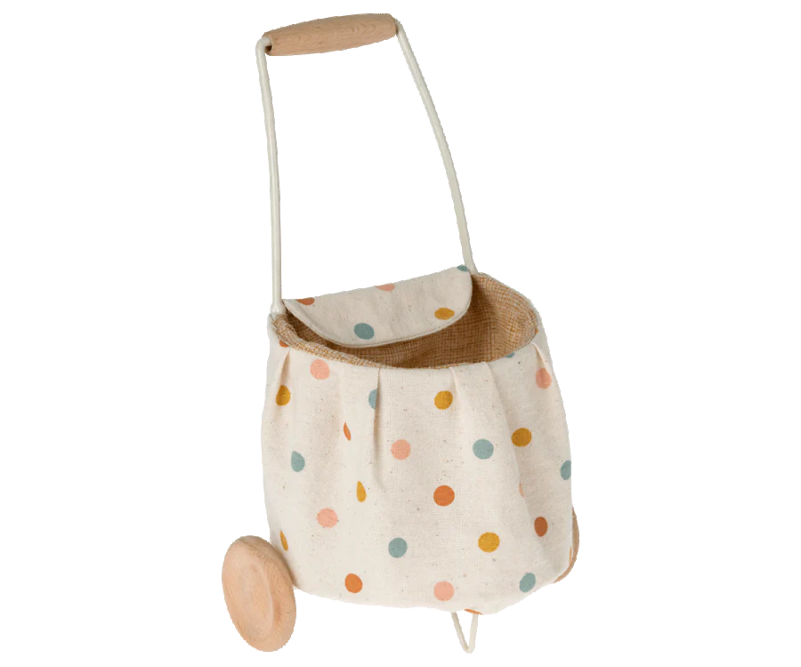 A children's Maileg Mini Bunny & Trolley Set toy shopping trolley on wheels, featuring a polka dot design on a beige background, displayed on a black background.