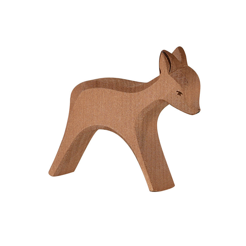 A small, brown, wooden figurine in the shape of a deer with smooth, simplified features, standing on all four legs. Its head is slightly lowered, and it has a minimalistic design with no detailed texture or markings. Handcrafted to inspire imaginative play, it resembles the Ostheimer Deer - Standing.