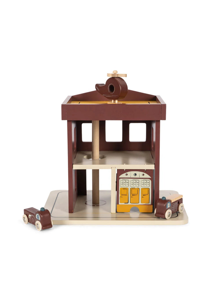 Konges Sloejd - Wooden Fire Station made of FSC-certified wood, featuring two small toy fire trucks and a helicopter on the roof.