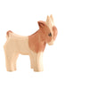 A handcrafted wooden figurine of a small, brown and beige Ostheimer Goat Kid - Standing with a simple, hand-painted design against a white background.
