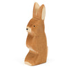 A handcrafted wooden carving of a Ostheimer Rabbit - Ears Up, depicted in a simplistic, stylized form with visible wood grain, isolated on a white background.