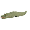 Handcrafted Ostheimer Crocodile figurine with articulated jaw, painted in green with yellow eyes and red detailing inside the mouth, isolated on a white background.