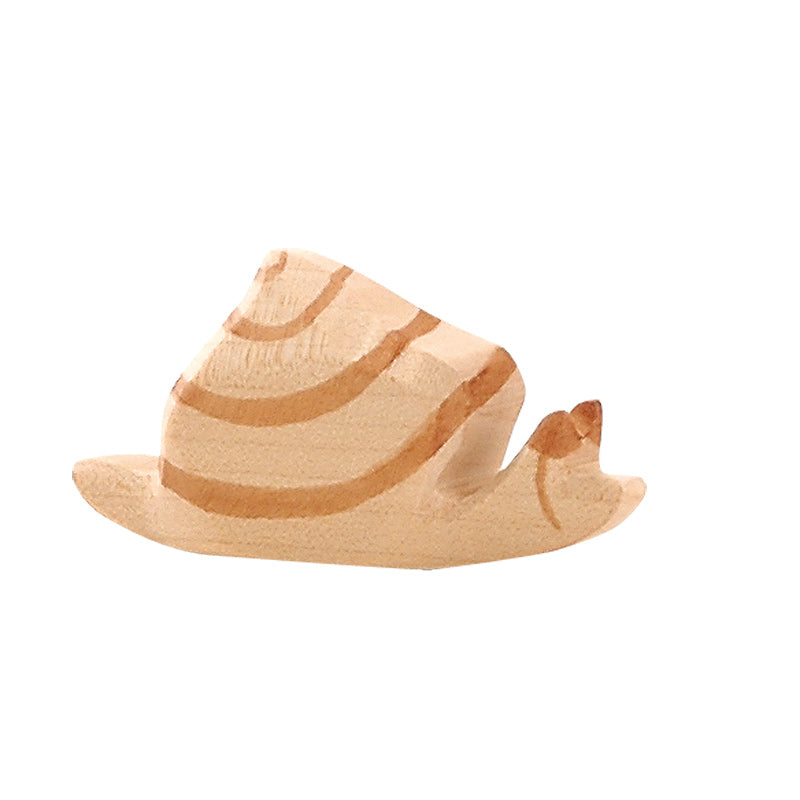 A small, handcrafted Ostheimer Snail carving with a wavy design and a noticeable dent on its top, isolated on a white background.
