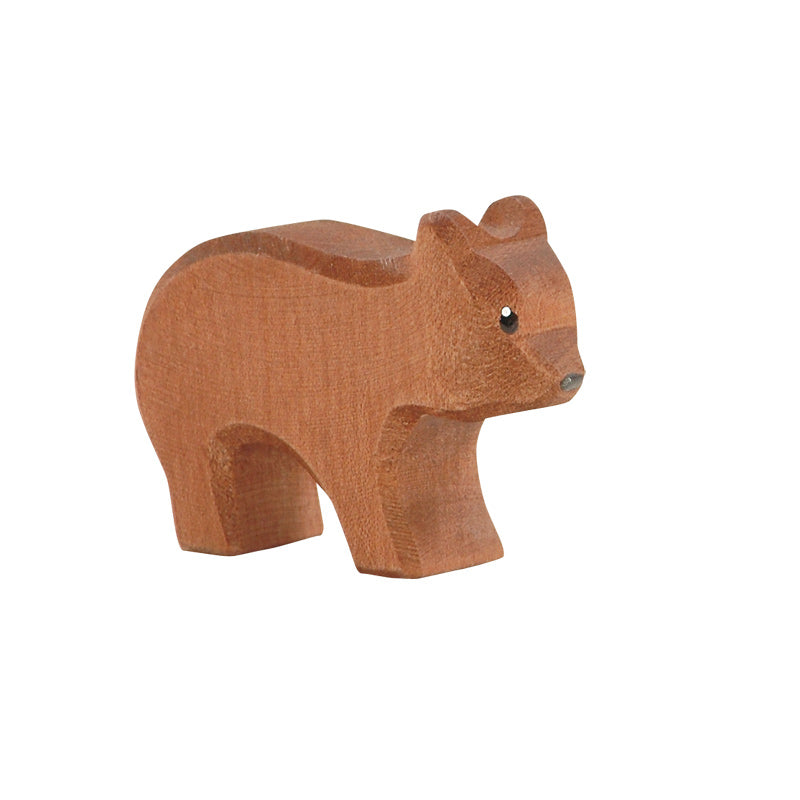 A simple Ostheimer Small Bear - Running figurine, handcrafted in a minimalistic style with visible wood grain, featuring small black eyes and standing on all four legs against a white background.